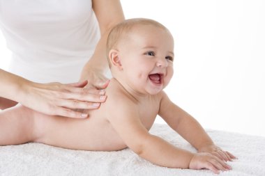 Mother massaging baby clipart