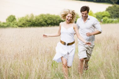 Couple running outdoors smiling clipart