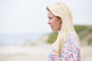 Woman standing at beach clipart