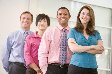 Business team standing indoors smiling clipart