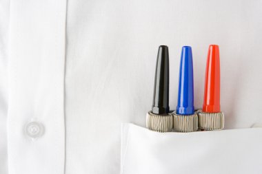 Close Up Of 3 Pens Neatly Sitting In A Mans White Shirt Pocket clipart