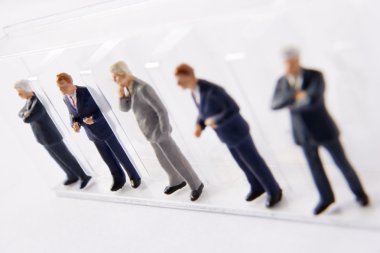 Line Of Businessmen Figurines clipart