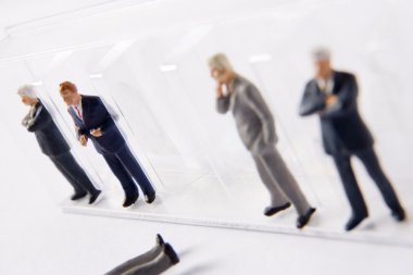 Row Of Businessman Figurines, With One Fallen Out Of Line clipart