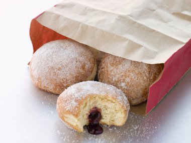 Bag Of Raspberry Jam Doughnuts With A Bite Taken clipart