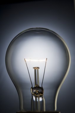 Close-Up Of Illuminated Light Bulb clipart
