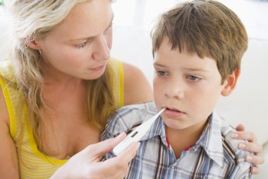 Boy Having His Temperature Measured clipart