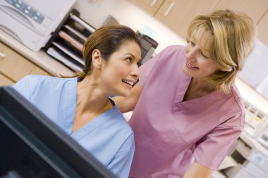 Nurses At The Reception Area Of A Hospital clipart