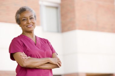 Nurse Standing Outside A Hospital clipart