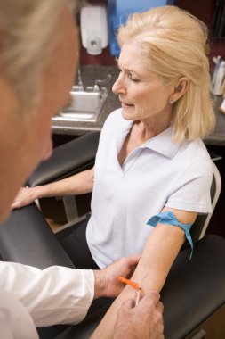 Middle Aged Woman Having Blood Test Done clipart