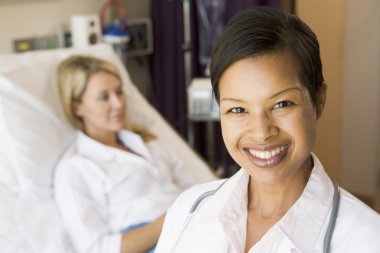 Nurse Standing In Patients Room clipart