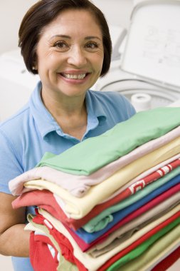 Woman Holding Folded Laundry clipart