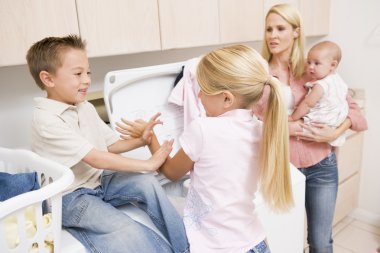 Siblings Fighting While Doing Laundry clipart