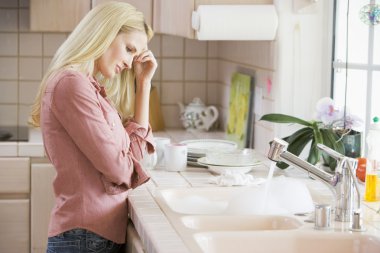 Woman Frustrated At Kitchen Counter clipart