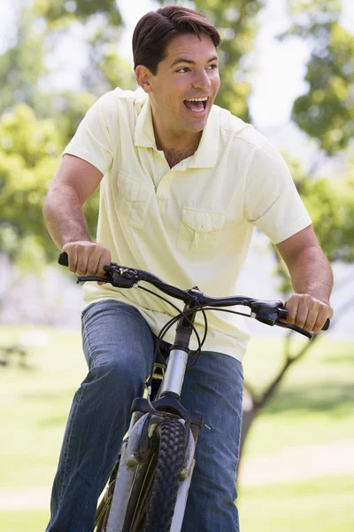 Man Outdoors Riding Bike Smiling — Stock Photo, Image