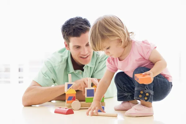 Father and daughter indoors playing and smiling — Stock Photo, Image