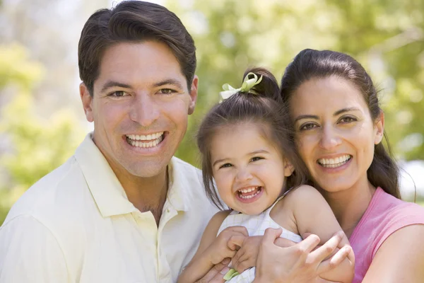 Family standing outdoors smiling — Stock Photo, Image