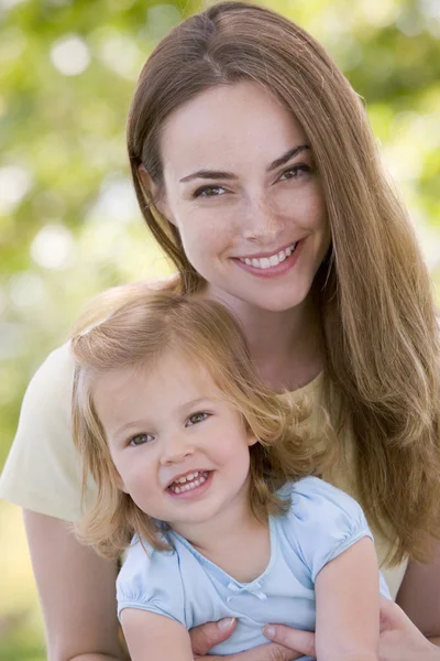 Mother Holding Daughter Outdoors Smiling — Stock Photo, Image