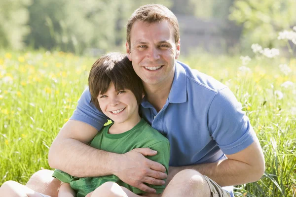 Father Son Sitting Outdoors Smiling — Stock Photo, Image