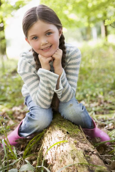 Young Girl Outdoors Woods Sitting Log Smiling — Stock Photo, Image