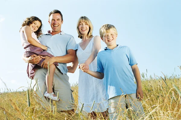 Family Standing Outdoors Holding Hands Smiling — Stock Photo, Image
