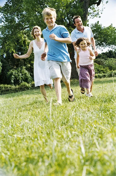 Family Running Outdoors Smiling — Stock Photo, Image