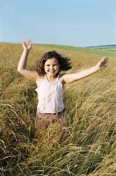 Young girl running outdoors smiling — Stock Photo, Image