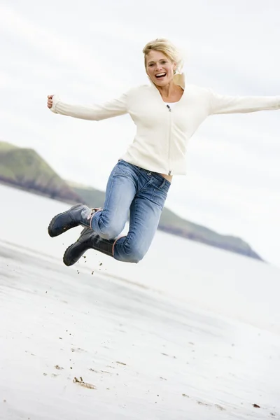 Vrouw Springen Het Strand Glimlachen — Stockfoto