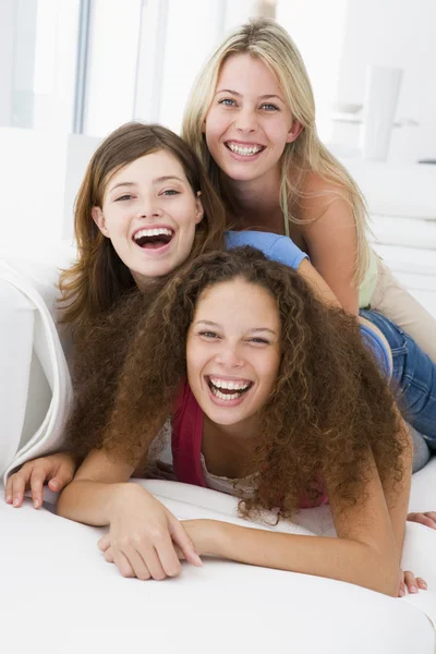 Three women in living room playing and smiling — Stock Photo, Image