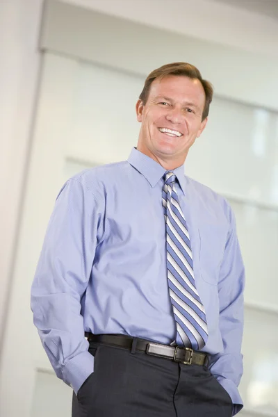 Businessman Standing Indoors Smiling — Stock Photo, Image