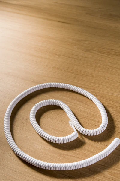 Telephone Cord Making 'At' Symbol — Stock Photo, Image