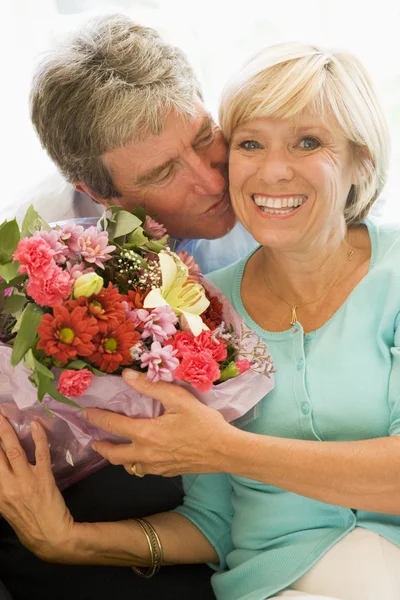 Esposo dando flores a la esposa besándose y sonriendo —  Fotos de Stock