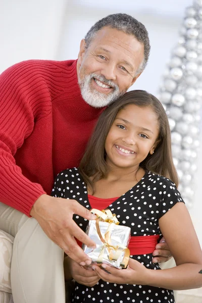 Grandfather Giving His Granddaughter A Christmas Present — Stock Photo, Image