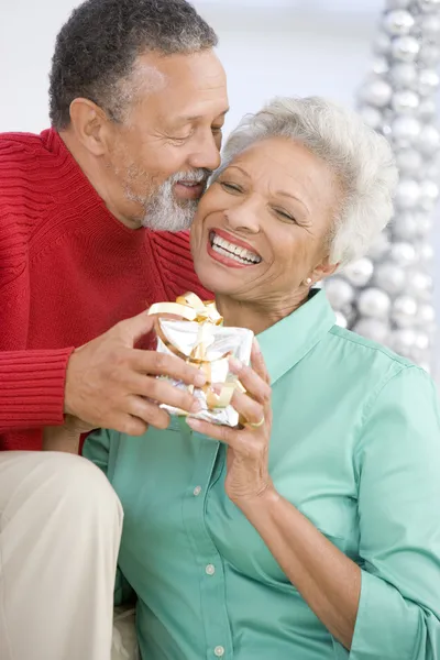 Senior Couple Exchanging Christmas Gift — Stock Photo, Image