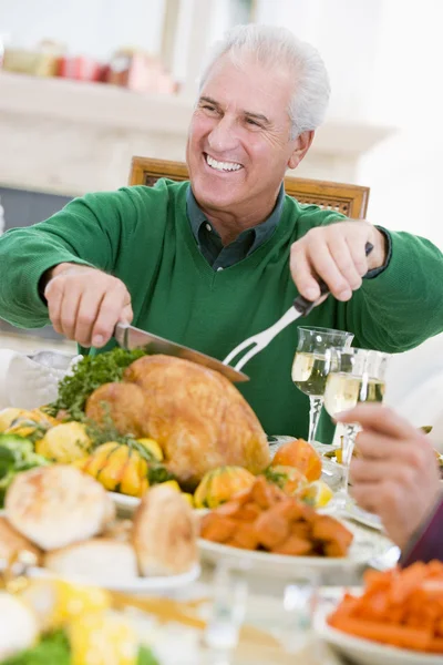 Man Carving Up Turkey At Christmas Dinner — Stock Photo, Image