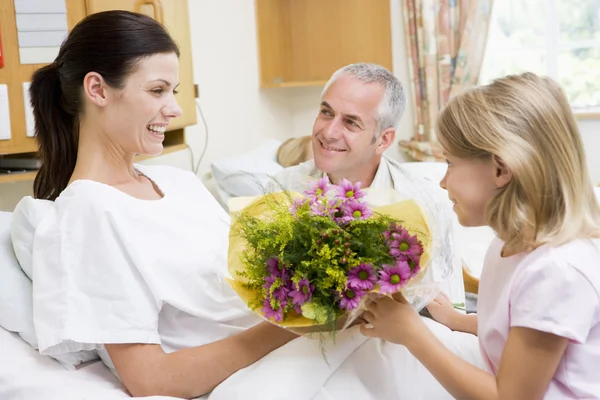 Young Girl Giving Flowers To Her Mother In Hospital — Stock Photo, Image