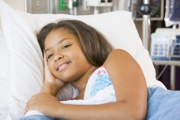 Молодая девушка лежит на больничной койке — стоковое фото
