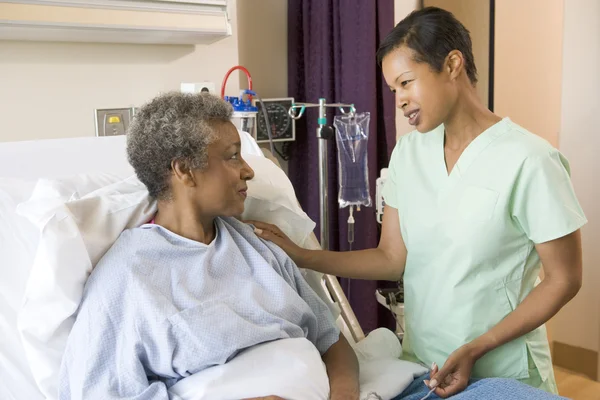 Sjuksköterska talar till äldre kvinna — Stockfoto