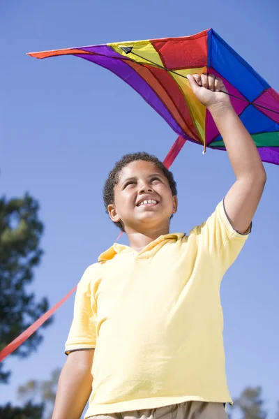 Young boy with kite outdoors smiling — Stock Photo, Image