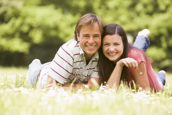 Couple Lying Outdoors Flower Smiling Stock Photo