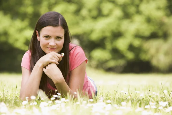 Woman Lying Outdoors Flower Smiling Stock Image