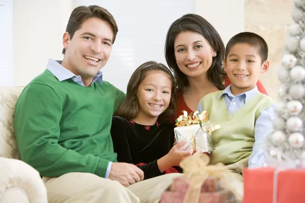 Family Sitting Sofa Together Holding Christmas Gift Stock Picture