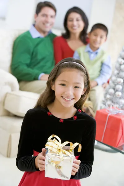 Young Girl Standing Holding Christmas Present Her Parents Royalty Free Stock Images
