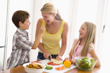 Mother And Children Prepare A meal,mealtime Together clipart