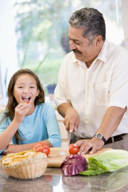 Grandfather And Granddaughter Preparing meal,mealtime Together clipart