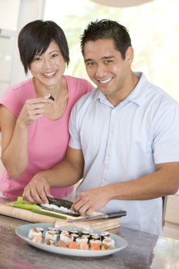 Couple Preparing Sushi Together clipart