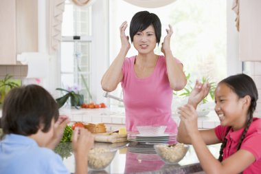 Children Play Fight While Having Breakfast clipart