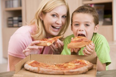 Mother And Son Eating Pizza Together clipart