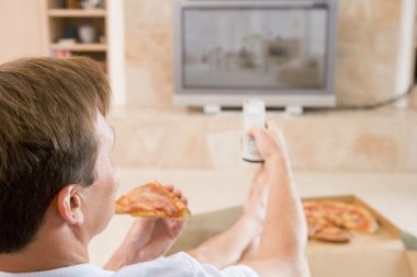 Man Enjoying Pizza While Watching TV clipart