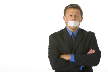 Businessman With His Arms Folded And His Mouth Taped Shut clipart