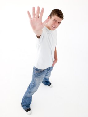 Teenage boy standing with hand up smiling clipart